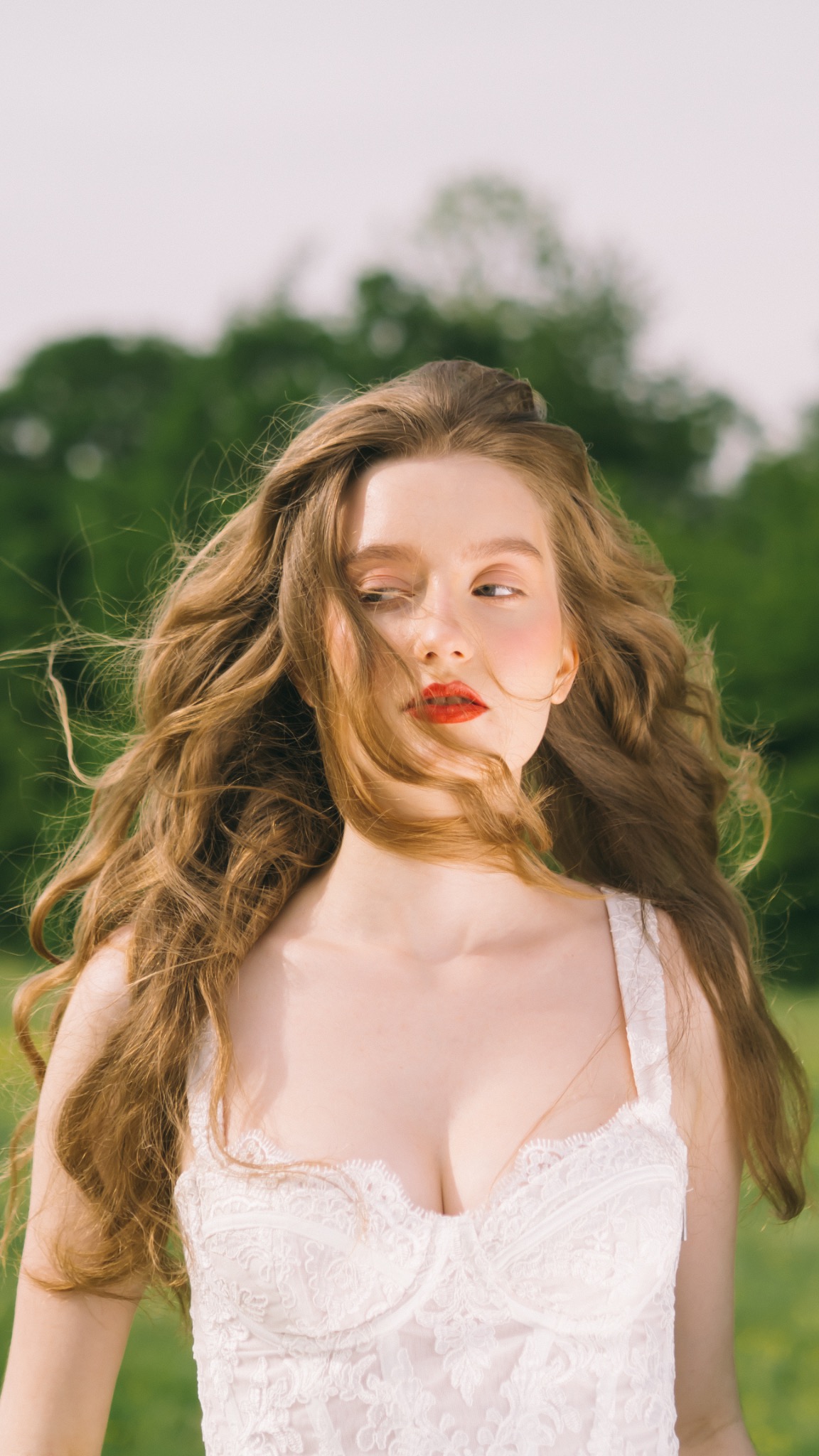 Outdoor portrait with flowing hair and a white dress